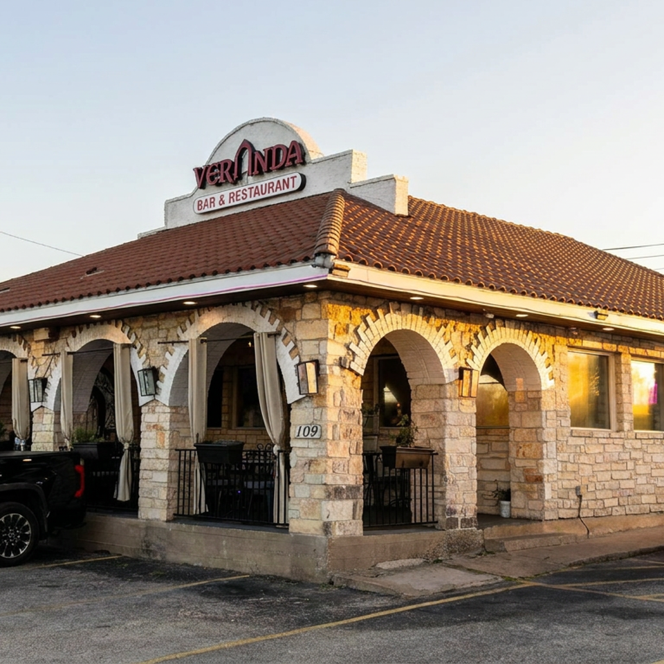 Veri Linda Bar & Restaurant exterior with stone arches, covered patio, tiled roof, and parked vehicles.